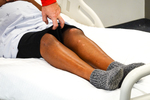 supine positionning for knee jerk testing (holding pants)