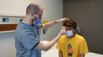 Cross cover testing when examining a patient for diplopia-head down/eyes up