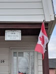 House with sign and flag